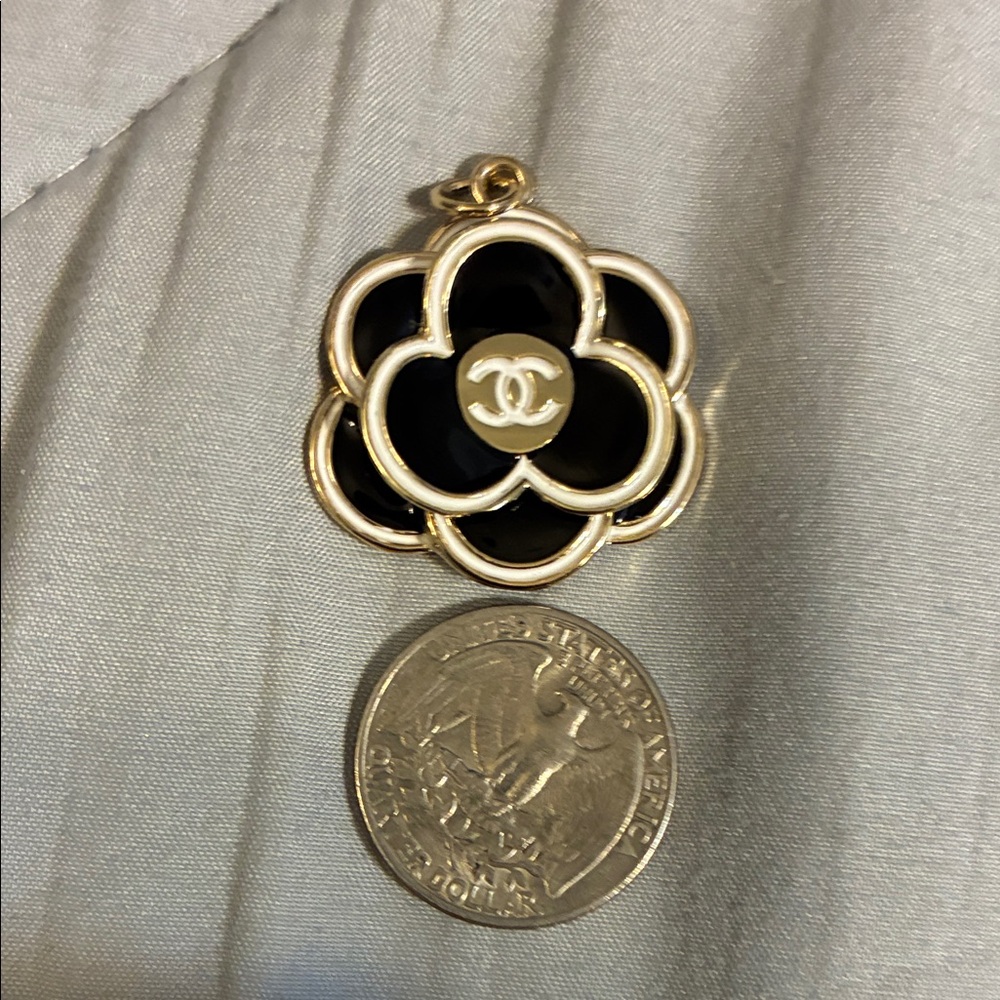 CHANEL Black and Gold Floral Brooch